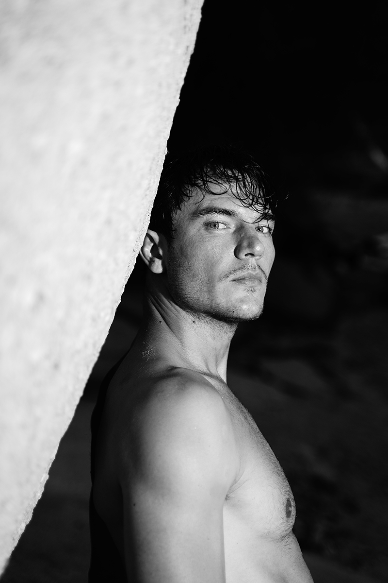 Portraits of male model by lake in black and white 
