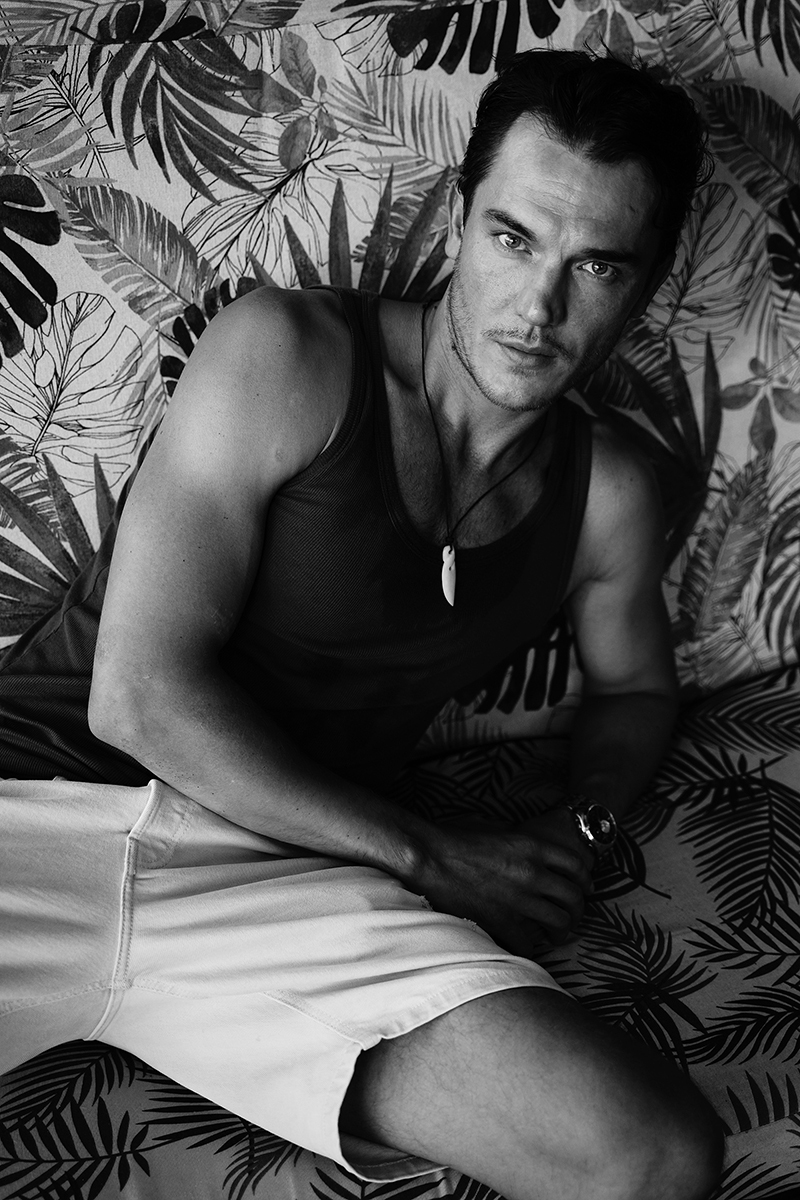 Portraits of male model by lake in black and white 