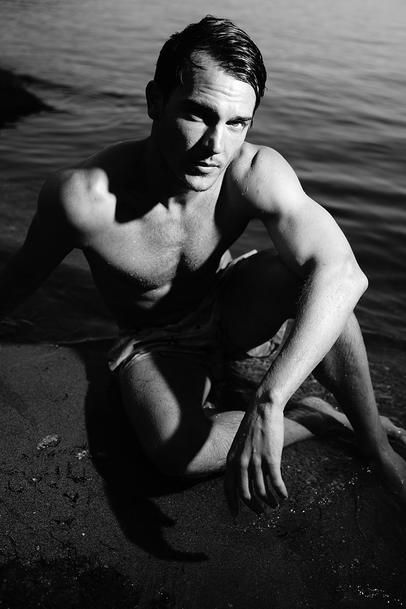 Portraits of male model by lake in black and white 